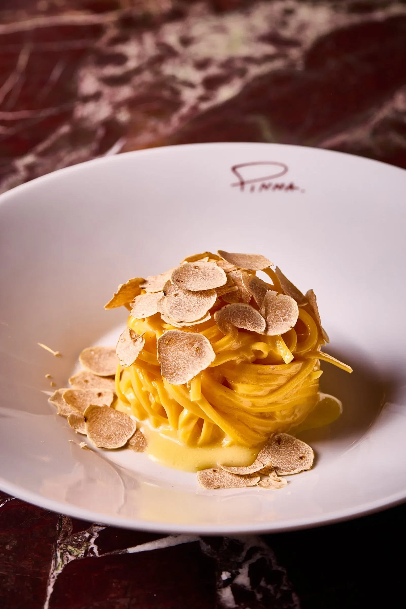 Pasta photographed on a Pinna-branded plate at Pinna Mayfair